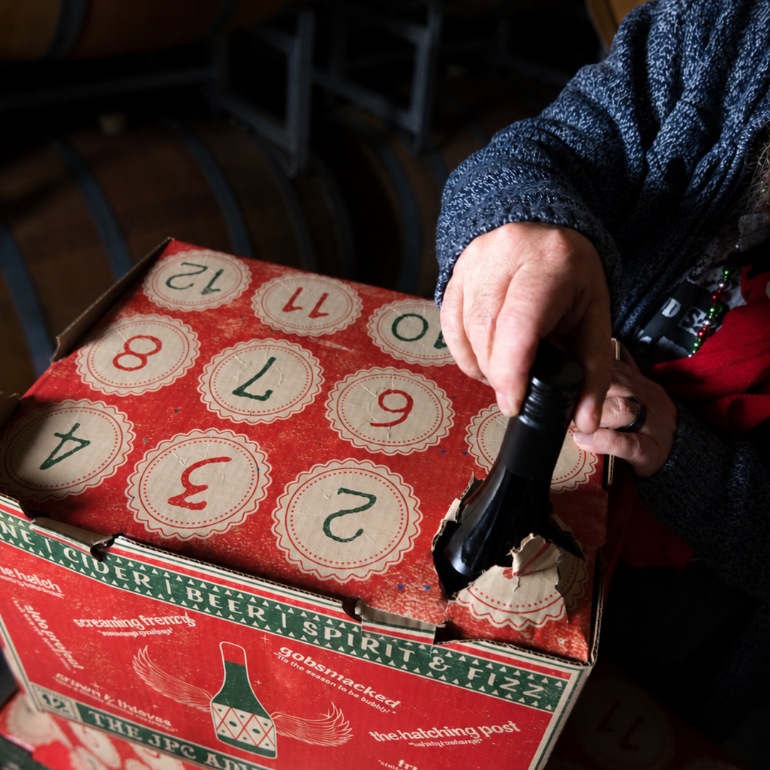 Opening The Hatch 12 Days of Wine Advent Calendar to reveal a full-size wine bottle